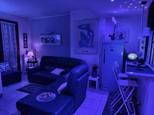 a purple living room with a couch and a table at La Casa Blu- Forum di Assago, Humanitas, Milanofiori, IEO in Rozzano