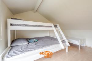 a bedroom with two bunk beds and a ladder at Zee en Polder 134 in Middelkerke