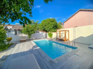 a swimming pool in the backyard of a house at Hasoa Villa in Morondava