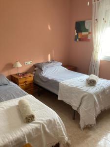 a bedroom with two beds and a window at Villa Sparrow, Arboleas in El Arroyo Aceituno +22 photos