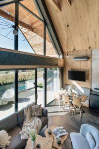 a living room with a couch and a table at Wierchy View - bespoke villas in Kościelisko