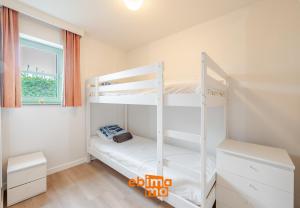 a bedroom with two bunk beds and a window at Nieuwendamme 69 with pool and parking in Nieuwpoort +18 photos