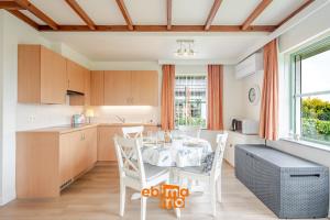 a kitchen and dining room with a table and chairs at Nieuwendamme 69 with pool and parking in Nieuwpoort