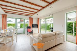 a living room with a couch and a table at Nieuwendamme 69 with pool and parking in Nieuwpoort