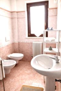 a bathroom with a white sink and a toilet at Appartamento Mare Nardo in Porto SantʼElpidio