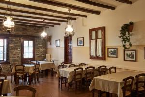 a dining room with tables and chairs in a building at Kentavros Hotel in Agios Lavrentios