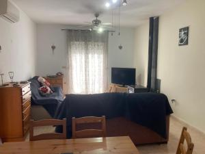 a living room with a couch and a table at Villa Sparrow, Arboleas in El Arroyo Aceituno