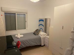 a small bedroom with a bed and a window at Pericos Gilet in Gilet