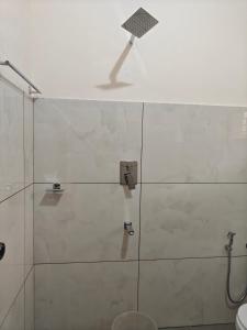 a bathroom with a shower with a glass door at Basuri Beach Resort in Varkala +42 photos