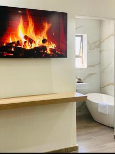 a fireplace in a bathroom with a bath tub and a fire place at Golfview luxury apartment in Richards Bay +35 photos
