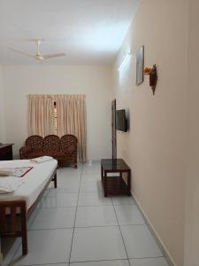 a living room with a bed and a couch at Basuri Beach Resort in Varkala