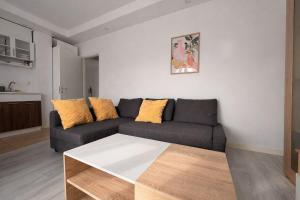 a living room with a couch and a table at Jupiter Suite #6people in Ştefăneştii de Sus