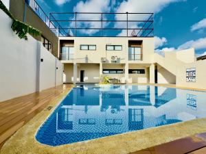 a swimming pool in the backyard of a house at Suite Escape Mactan , condo with balcony near Mactan Newtown and Mactan Airport in Mactan