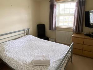 a bedroom with a bed and a television and a window at Woodstock in York