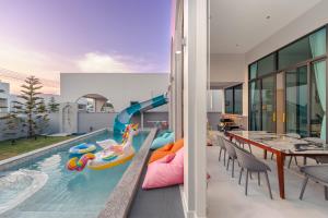 a house with a pool with a inflatable slide at Baby Blue pool villa in Ban Bo Prakhon