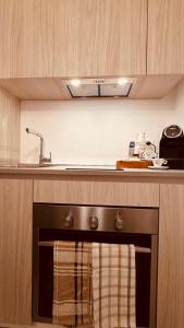 a kitchen with a stove with a sink above it at Dal Nadìr allo Zènit room in Polignano a Mare +8 photos