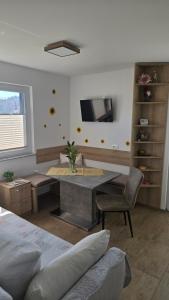 a bedroom with a desk and a table with a chair at Mountain Paradise Apartment in Zgornje Gorje