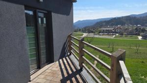 a balcony of a building with a view of a field at Mountain Paradise Apartment in Zgornje Gorje