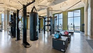 a gym with a punching bag and weights at Sentral Forme Houston in Houston