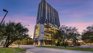 a tall building with lights on in a street at Sentral Forme Houston in Houston