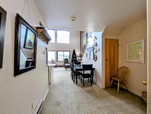 a dining room and kitchen with a table and chairs at Edgewater 1448 by SummitCove Lodging in Colorado in Keystone