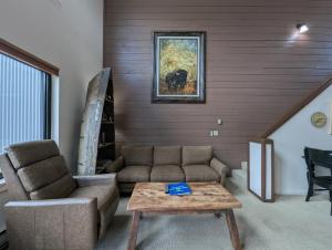 a living room with a couch and a coffee table at Edgewater 1448 by SummitCove Lodging in Colorado in Keystone