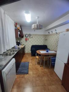 a small kitchen with a table and a dining room at OrlaBela in Manta Rota