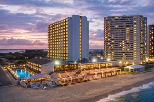 a hotel on the beach in front of a building at Ashore Oceanfront Hotel by Marriott in Ocean City