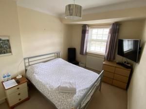 a bedroom with a bed and a flat screen tv at Woodstock in York