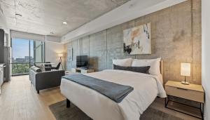 a bedroom with a large bed and a couch at Sentral Forme Houston in Houston +45 photos