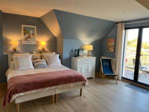 a bedroom with a large bed and a chair at Au pré des chants in Saint-Philbert-des-Champs +51 photos