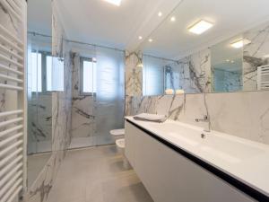 a bathroom with a tub and a sink and a shower at Modern flat in Piazza Fontana in Lignano Sabbiadoro