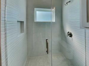 a shower with a glass door in a bathroom at All Decked Out in Padre Island
