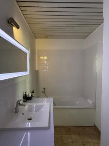 a bathroom with a sink and a bath tub at Hotel du Pot d'Etain in Chalons en Champagne +42 photos