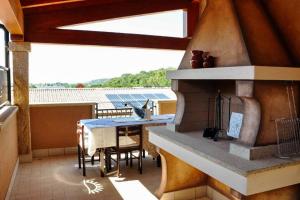 a patio with a stove and a table on a balcony at Villa Chia 2 in Chia