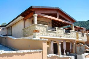 a house with a stone fireplace on the side of it at Villa Chia 2 in Chia +8 photos