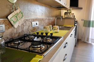 a kitchen with a stove top oven in a kitchen at Villa Chia 2 in Chia