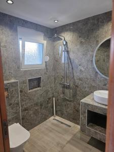 a bathroom with a shower and a sink at Iliana Apartment in Afantou