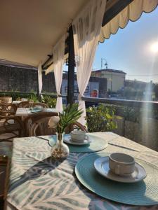 a table with plates and cups on top of a patio at Hotel Marina in Torri del Benaco +60 photos
