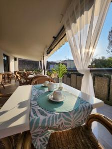 a table on a balcony with a table and chairs at Hotel Marina in Torri del Benaco