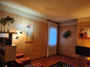 a living room with a couch and a television at Hotel Marina in Torri del Benaco