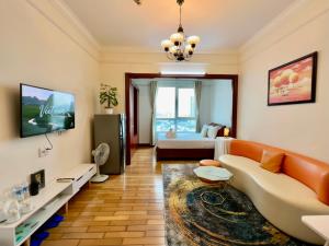 a living room with a couch and a tv at Diny Aparthotel - Rooftop Pool - The Manor 2 in Ho Chi Minh City