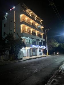 a building with lights on the side of a street at RUKA Hotel in Punta Cana