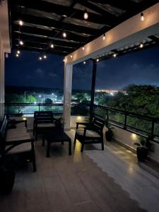a room with benches on a balcony at night at RUKA Hotel in Punta Cana