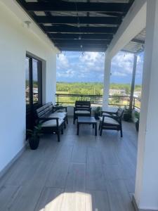 a porch with benches and a view of the ocean at RUKA Hotel in Punta Cana +46 photos