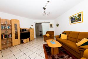 a living room with a couch and a table at Ferienwohnung am Moselufer in Cochem