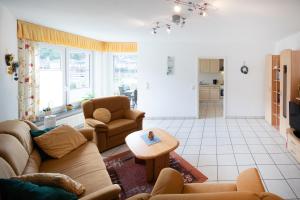 a living room with a couch and a table at Ferienwohnung am Moselufer in Cochem