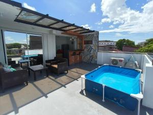 a patio with a hot tub on a roof at Casipe Transient House in Tanay