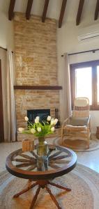 a living room with a coffee table and a fireplace at Casa el Montcel, a unique chalet with roofterrace and shared pool in Denia