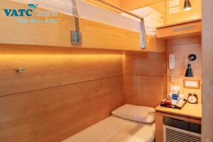 a small room with a bench in a tiny house at VATC Sleep Pod Terminal 2 in Noi Bai +37 photos